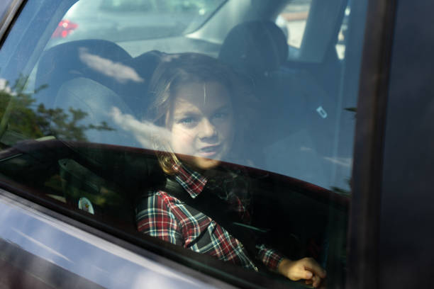 istock Child inside the car seen from outside through the window 1667974380