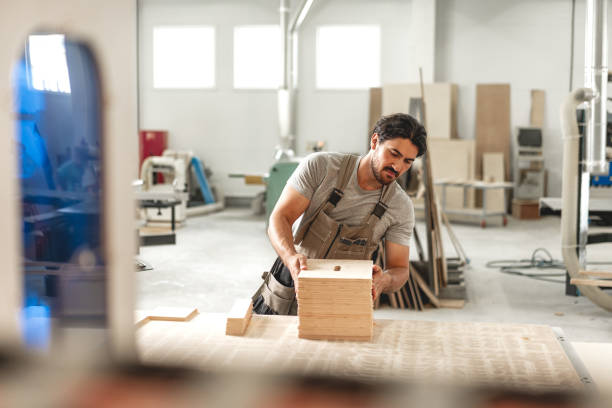istock Young man doing woodwork in carpentry factory 1667976305