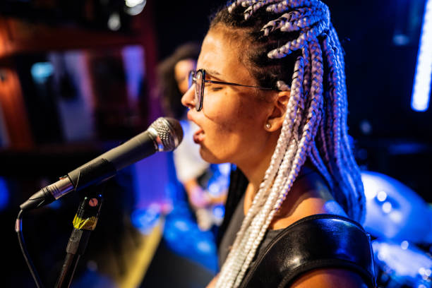 istock Young woman singing on a show 1667992845