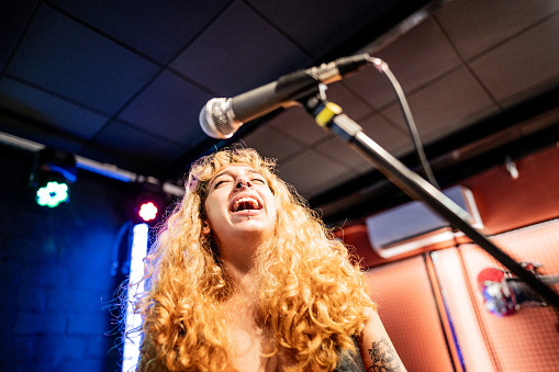 Young woman singing on a show