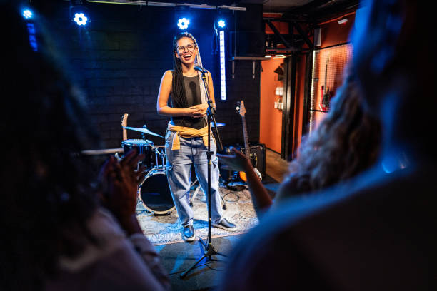 istock Young woman talking during stand-up comedy show 1667997781