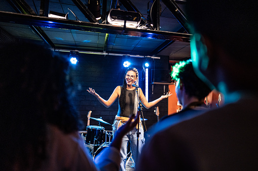 Young woman talking during stand-up comedy show