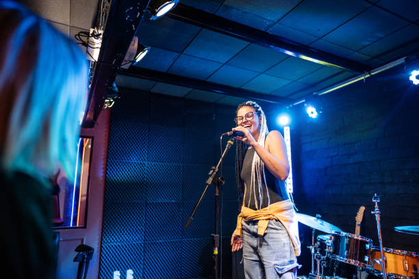 istock Young woman talking during stand-up comedy show 1667997787