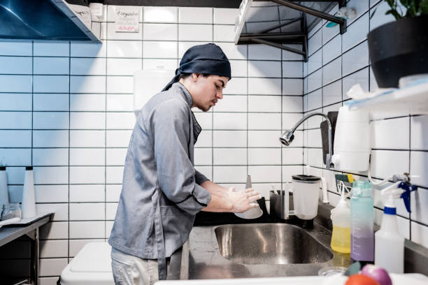 istock Chef young man washing hands on a commercial kitchen 1668002093
