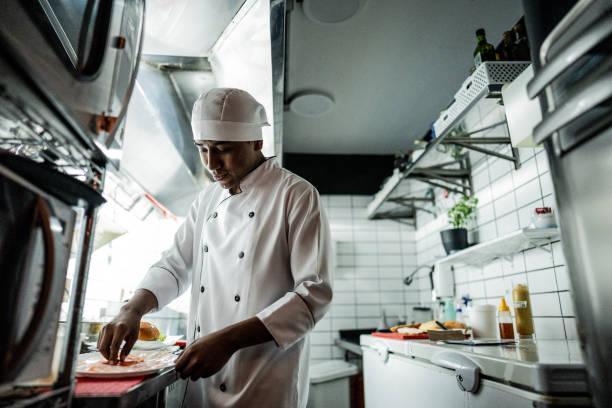 istock Chef young man making a sandwich on a commercial kitchen 1668002098
