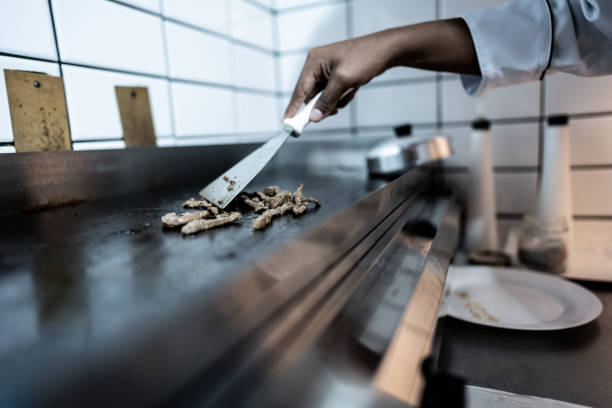 Close-up of a man roasting meat on a commercial kitchen
