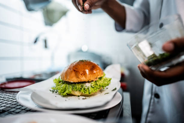 Close-up of a man making a sandwich on a commercial kitchen