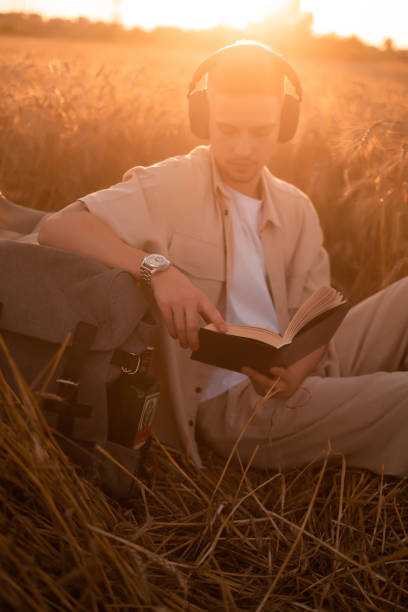 istock man holding up Bible in a wheat field 1668005427