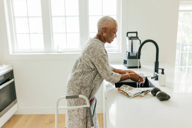 istock Senior women washing hands in the kitchen 1668018664