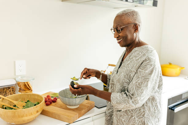 istock Senior women preparing a lunch in the domestic kitchen 1668018671
