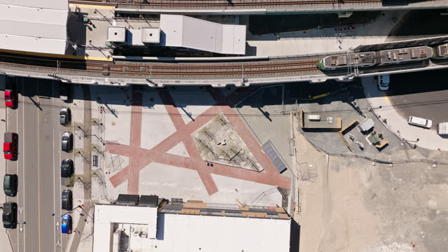 Slow Motion Top Down Aerial Shot of Train Leaving Lechmere Station in Cambridge, MA