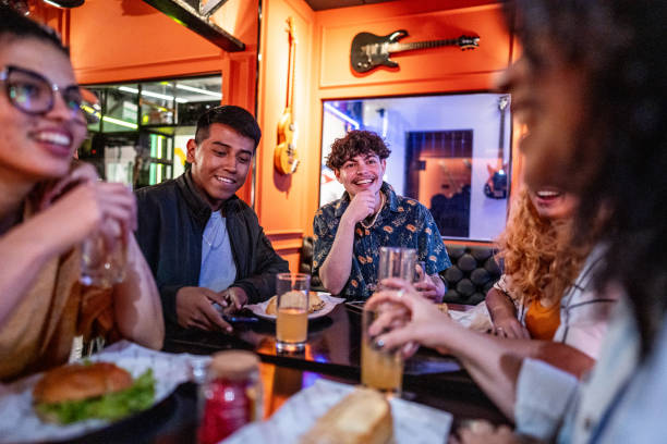 istock Friends talking and eating on a restaurant 1668027946