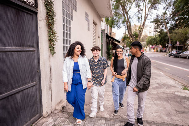 istock Friends talking and walking on the street 1668039320