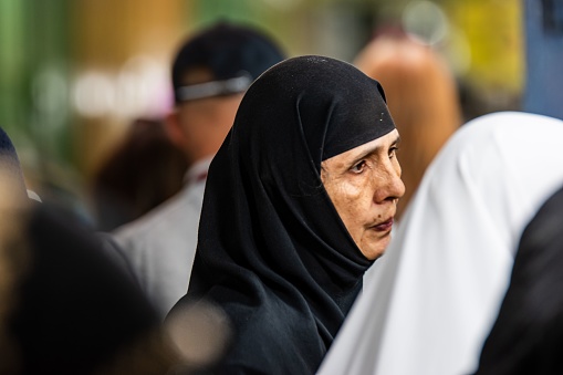 jerusalem, Israel – June 14, 2023: An elderly woman with grey hair wearing abayas, smiling at the camera