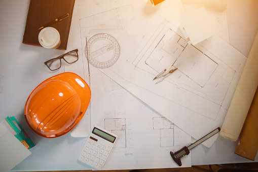 Equipment and drawings lying on desks inside the offices of architects and engineers. background of an architect's workbench getting ready for work to achieve the desired outcome of the client.