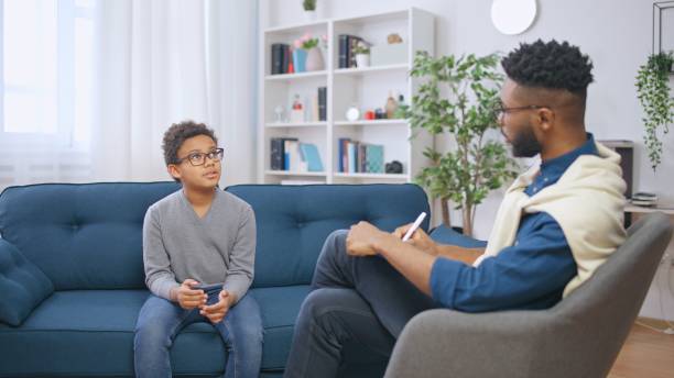 istock School psychologist communicating with a boy and taking notes, child counselling 1668128382