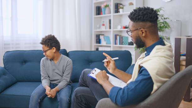 istock Psychologist providing professional help to a troubled boy, correction of negative behavior in school 1668128829
