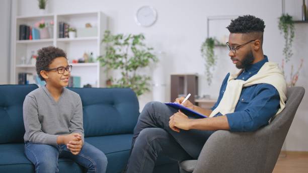 istock Little boy smiling while communicating with a psychologist, child therapy, mental help 1668128835