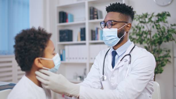 istock Little boy visiting doctor's office, pediatrician checking child's lymph nodes, sore throat 1668128875