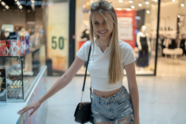 Close up of adult woman shopper standing in candy store in shopping center