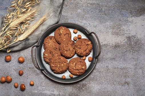 Chocolate chip cookies and glass of milk isolated on white background.