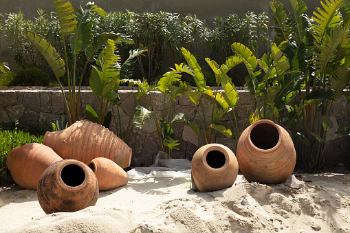 amphoras with decoration on the sandy beach