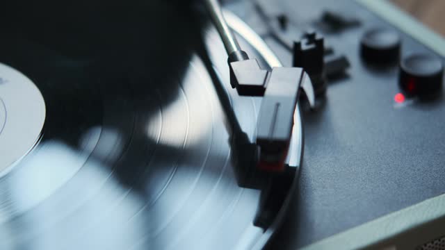 Close Up of Female Hands Operating a Vinyl Record Player