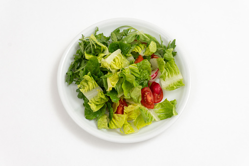 Fresh mixed salad on a white background