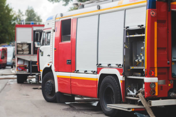 istock Fire fighting equipment in the city, with red fire engine truck during fire fighting operation in the city streets, vehicle and firefighters extinguish blaze, emergency and rescue service vehicle 1668262775