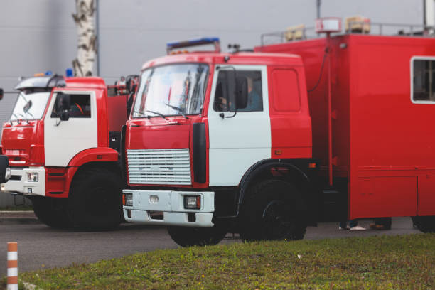 istock Fire fighting equipment in the city, with red fire engine truck during fire fighting operation in the city streets, vehicle and firefighters extinguish blaze, emergency and rescue service vehicle 1668262789