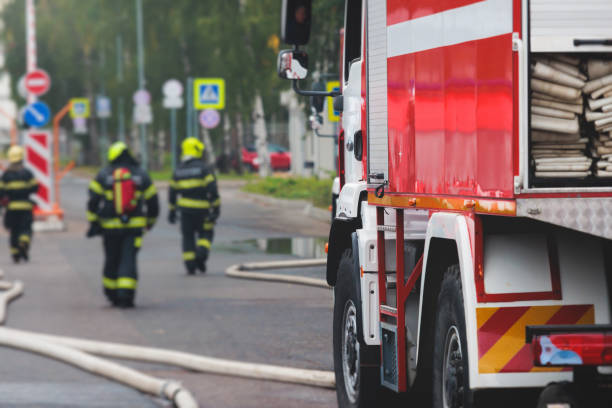 istock Fire fighting equipment in the city, with red fire engine truck during fire fighting operation in the city streets, vehicle and firefighters extinguish blaze, emergency and rescue service vehicle 1668263138