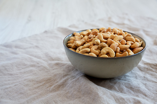 Homemade Roasted and Salted Cashews in a Bowl, side view. Copy space.