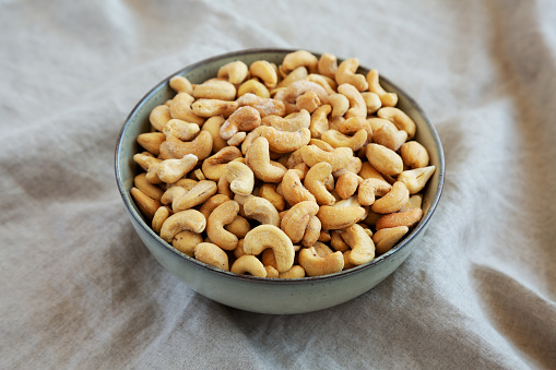 Homemade Roasted and Salted Cashews in a Bowl, side view. Close-up.