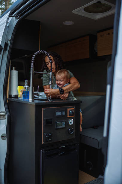 istock Mother helps baby son wash hands in a camper van 1668283922