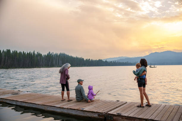 istock Multigenerational family relaxing on lakeside dock 1668284451
