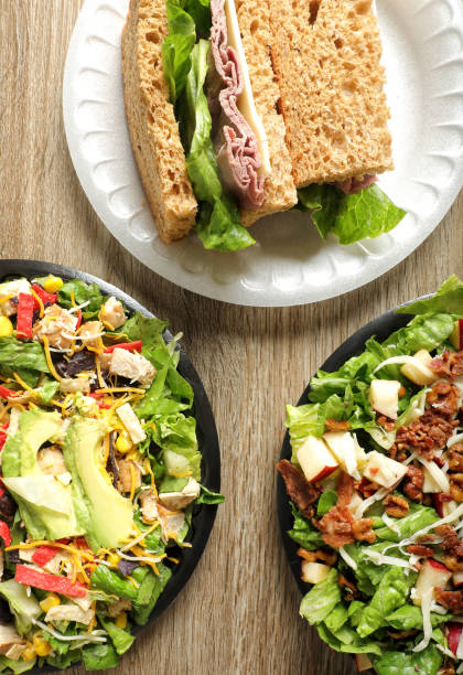 istock Green salad bowls and roast beef sandwich 1668298514