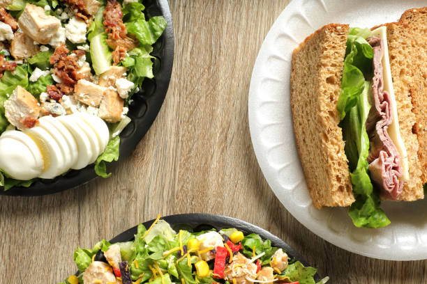 istock Green chicken salad bowls and roast beef sandwich 1668298518