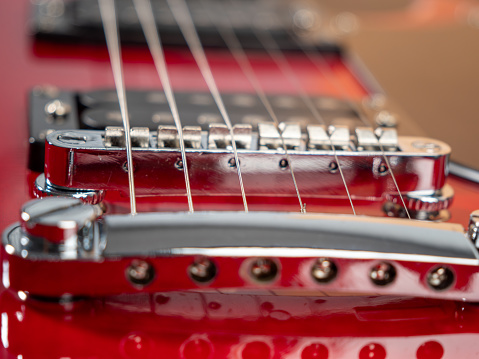 Red six-string electric guitar. Electric guitar close-up.