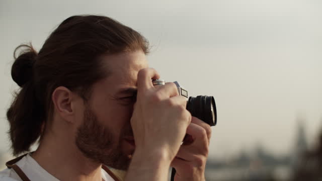Bearded male traveler photographing sightseeing during journey