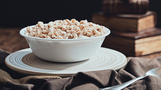 Puffed wheat cereal in a bowl with milk