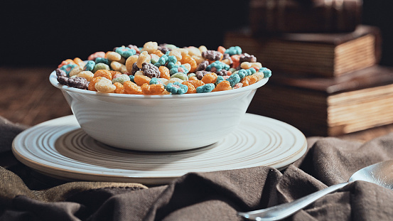 Colorful  colorful fruit cereal in a bowl with milk