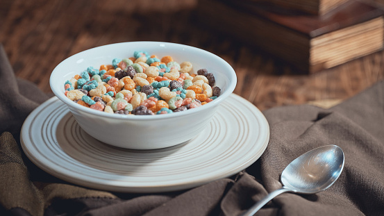 Colorful  colorful fruit cereal in a bowl with milk