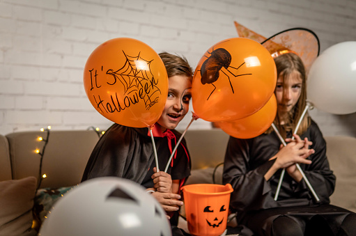 Children enjoying halloween party at home