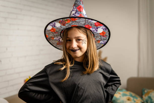 Children in costumes having fun for halloween at home