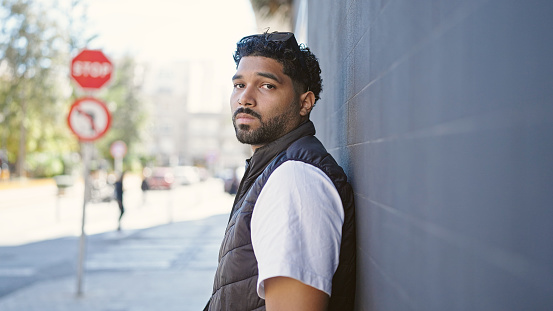 African american man standing with serious expression at street