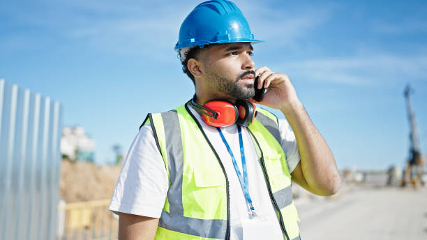 istock African american man builder talking on smartphone at street 1668410140