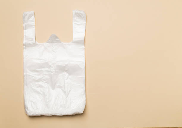 Plastic bag on color background, top view