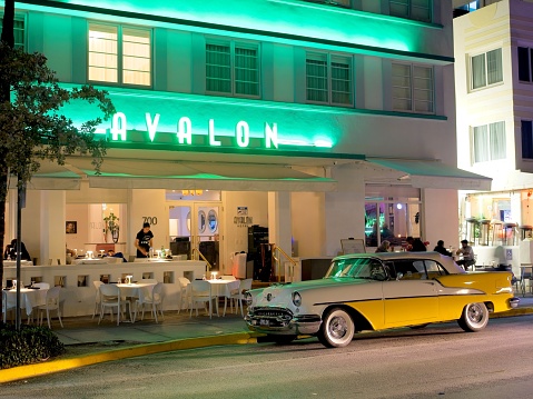 Miami Beach, FL - USA, February 1, 2023. Historic 1951 Oldsmobile parked in front of the Avalon hotel in the heart of Miami Beach's historic art deco district.