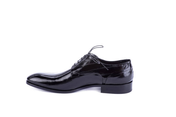 istock Classic black patent leather men's shoe isolated on a white background with copy space. Side view. Formal men's accessories, groom shoes. Outlet marketing layout. Discount, season sales. 1668468114