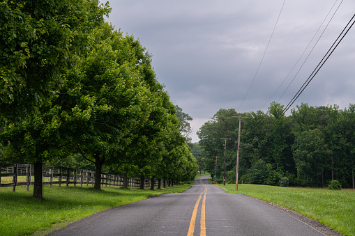 Beautiful moody summer day in rural New Jersey featuring road and farmland. Agriculture remains the dominant characteristic of New Jersey into the present day.